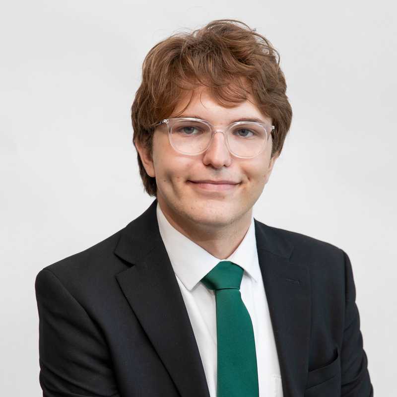 Elton in a suit and green tie